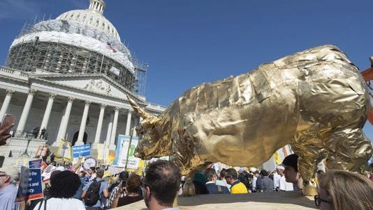 Protesters carry a replica of the Wall Street Bull on Capitol Hill in April 2016.