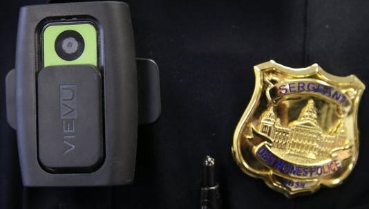 A body camera and badge worn by a Des Moines police officer.