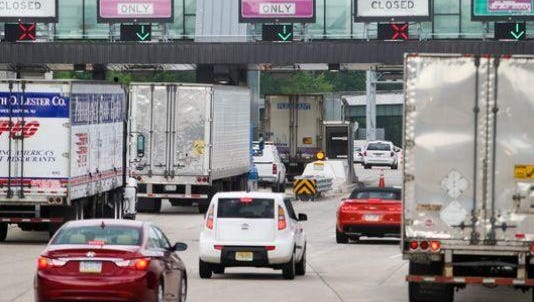 Vehicles approach the Interstate 95 toll plaza near Newark. Two cash lanes at the toll will close Jan. 3 until the end of March.
