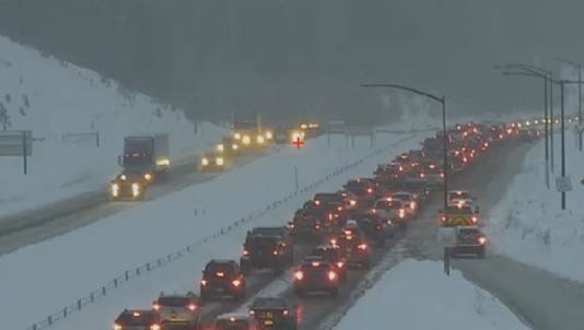 In this file photo, cars sit in traffic on a snow-covered Interstate 70. Colorado's high country is expected to get around 10 inches of snow from Saturday at 3 p.m. until Sunday morning.