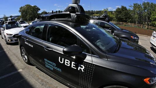 A group of self driving Uber vehicles position themselves to take journalists on rides during a media preview at Uber's Advanced Technologies Center in Pittsburgh.