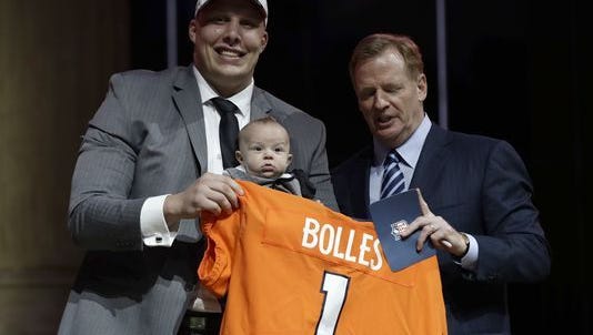 Utah's Garett Bolles, left, and son, Kingston, pose with NFL commissioner Roger Goodell after being selected by the Denver Broncos during the first round of the 2017 NFL football draft, Thursday, April 27, 2017, in Philadelphia.