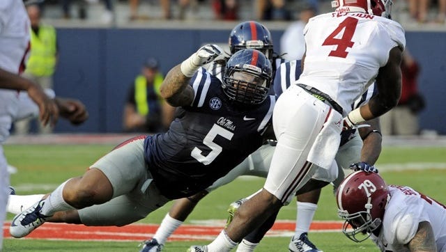 Mississippi defensive tackle Robert Nkemdiche (5) pressures Alabama running back T.J. Yeldon (4) during the second half of an NCAA college football game in Oxford, Miss., Saturday, Oct. 4, 2014. (AP Photo/The Daily Mississippian, Thomas Graning)
