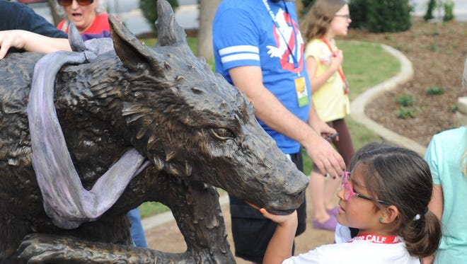 A youngster stares into the face of the Big Bad Wolf following the grand-opening ceremony of the Adamson-Spalding Storybook Garden on Thursday at the Abilene Convention Center.