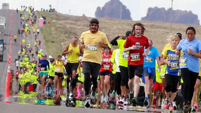 Runners in the half marathon make their way up U.S. Highway 491 during the Shiprock Marathon on May 7, 2016, in Shiprock.