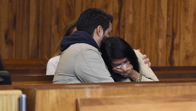 Alexandra Caro being comforted by her son-in-law, Jaime Borja, at the sentencing of Owen Soltis in the killing of her son, Leandro Mendoza, 21.