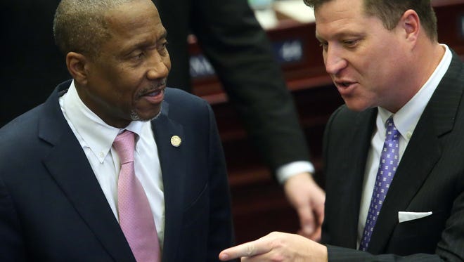 Rep. Darryl Rouson, D- St. Petersburg, (left) confers with Sen. Jeff Brandes, R-St. Petersburg, on the House floor during session March 9, 2016, in Tallahassee. Rouson and Brandes have filed legislation to reform when and how it's decided that Florida drivers' licenses are suspended.