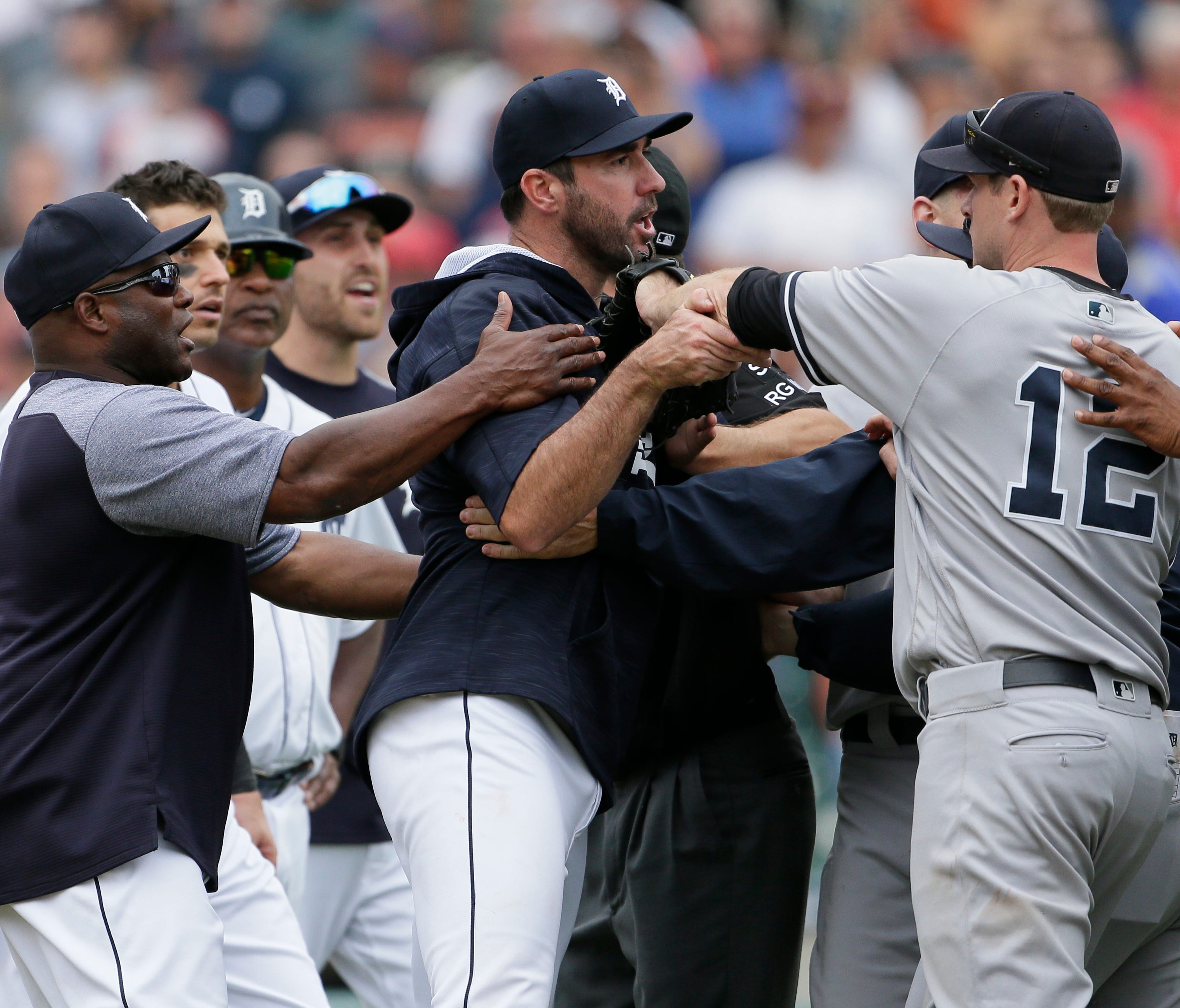 Tigers hitting coach Lloyd McClendon, left, tries to pull Justin Verlander, center, away from Yankees first baseman Chase Headley during the second bench-clearing of the Tigers' 10-6 win over the Yankees on Thursday, Aug. 24, 2017, at Comerica Park.