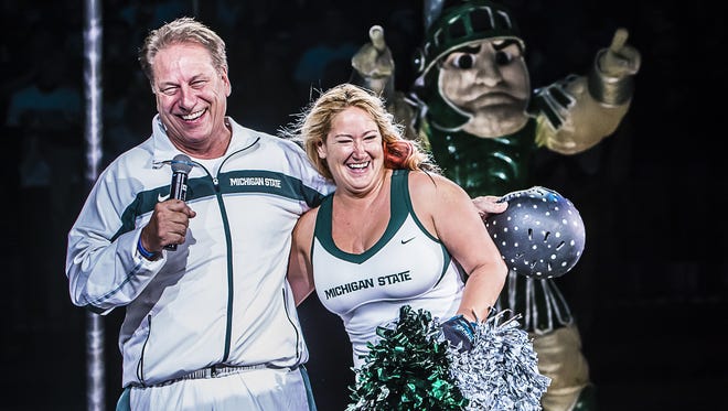 Tom Izzo, left, shares a laugh with Jennifer Smith-Schneider, who was shot out of a cannon in Izzo?s place on Friday during Michigan State's Midnight Madness at the Breslin Center