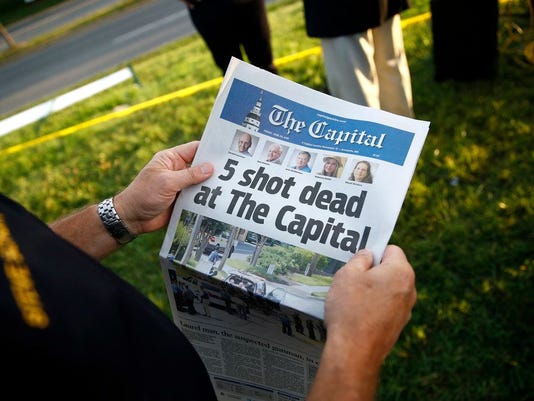 photography of hands holding a newspaper