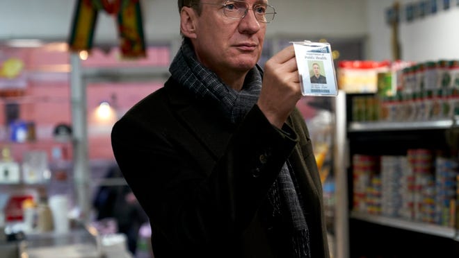 Jim (David Thewlis), a food inspector, flashes his badge at a possible violator.