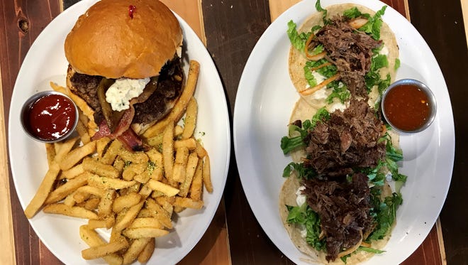 At left, the Frances burger from Delight, 502 N. Oregon St., Suite A, is loaded with blue cheese, bacon, berry-basil preserves and green chili. At right, the lamb tacos are served on corn tortilla and topped with tzatziki, romaine lettuce, marinated onions and a side of spicy sauce.