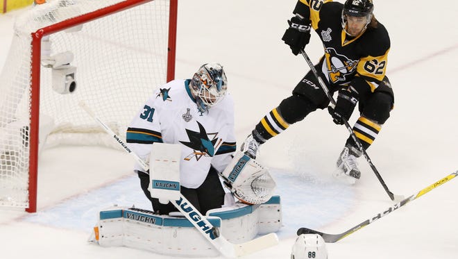 San Jose Sharks goalie Martin Jones (31) makes a save against Pittsburgh Penguins left wing Carl Hagelin (62) during Game 5 of the Stanley Cup Final.