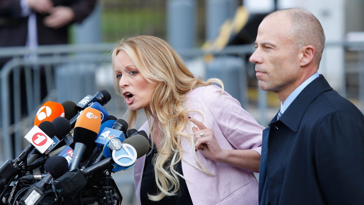 Adult-film actress Stephanie Clifford, also known as Stormy Daniels speaks outside US Federal Court with her lawyer Michael Avenatti (R) in Lower Manhattan, New York on April 16, 2018.  Stormy Daniels, the porn star who claims to have had a consensual sexual encounter with Donald Trump a decade ago, said April 17, 2018 that she is pursuing legal action against the president because she is "done being bullied.""I'm tired of being threatened, intimidating me, and trying to say that you'll ruin my life and take all my money and my house," Daniels said on ABC's "The View.""I'm done being bullied," Daniels said of legal threats from Trump's lawyer Michael Cohen, who is now embroiled in his own legal troubles."I'm done," Daniels said.