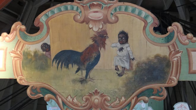 A painted panel at the Ontario Beach Park carousel featured two caricatures of African-Americans.