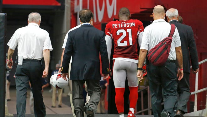 Arizona Cardinals cornerback Patrick Peterson (21) is walked to the locker room after being injured during the 2nd quarter against he Philadelphia Eagles in their NFL game Sunday, Oct. 26, 2014 in Glendale.