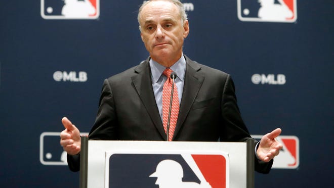 In this Nov. 21, 2019, file photo, baseball commissioner Rob Manfred speaks to the media at the owners meeting in Arlington, Texas. The financial feud between Major League Baseball and its players took a step toward an agreement that could lead to a pandemic-delayed season after Commissioner Manfred traveled to Arizona to meet with players' union head Tony Clark.