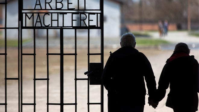 
In this Jan. 27, 2012 photo, a couple walks past the slogan 'Arbeit Macht Frei' (Work Sets You Free) at the main entrance of the Sachsenhausen Nazi concentration camp on the international Holocaust remembrance day in Oranienburg, Germany. 
