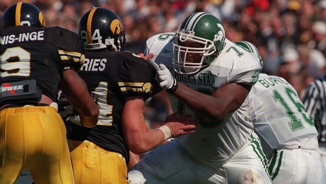 Flozell Adams, here blocking Iowa's Jared DeVries, was an All-American left tackle in 1997.