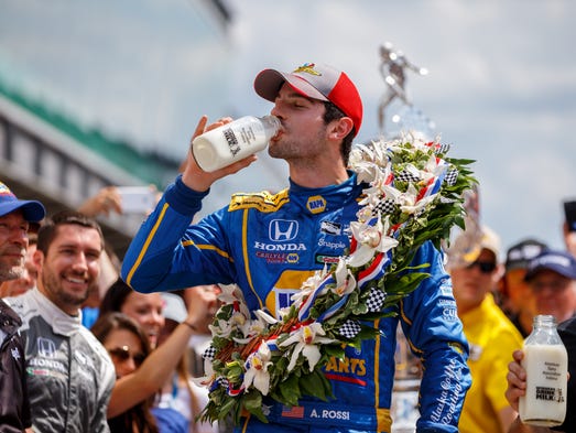 Alexander Rossi celebrates with the traditional bottle
