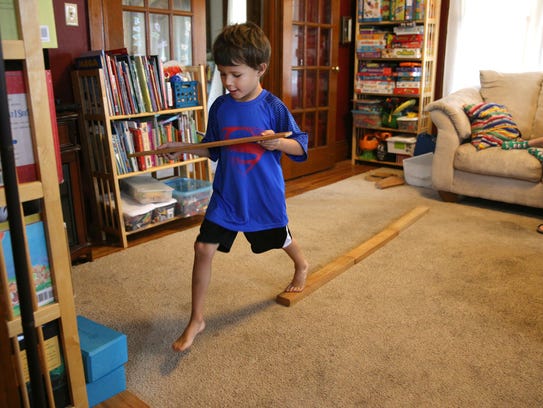 Schuyler Peck, 5, does some balance exercises to help