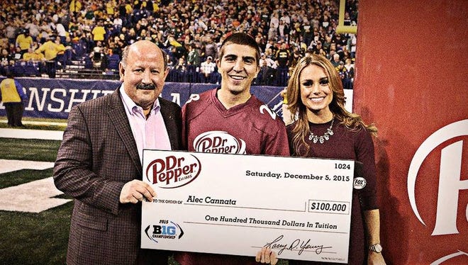 University of Wisconsin-Stevens Point student Alec Cannata poses after winning $100,000 in the Dr Pepper Tuition Giveaway on Dec. 5, 2015 during the Big Ten championship at Lucas Oil Stadium in Indianapolis.