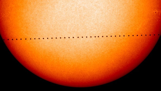 Mercury makes its transit across the face of the sun n this composite image from 2006.