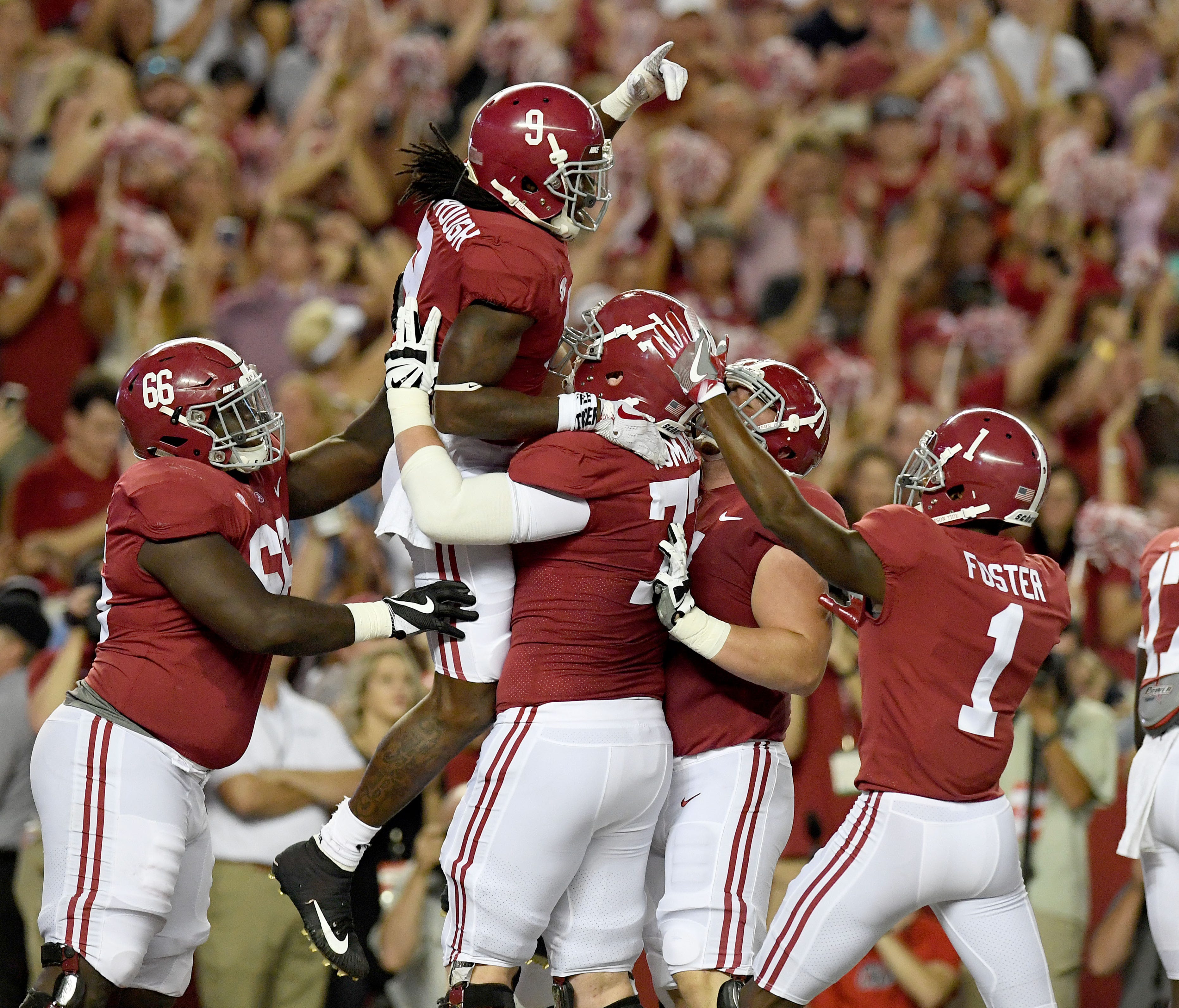 Alabama running back Bo Scarbrough (9) celebrates his touchdown in the end zone with teammates.