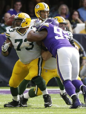 Green Bay Packers offensive guard Jahri Evans (73) and center Corey Linsley (63) provide pass protection for quarterback Brett Hundley (7) during the third quarter of their game against the Minnesota Vikings Sunday, October 5, 2017 at U.S. Bank Stadium in Minneapolis.