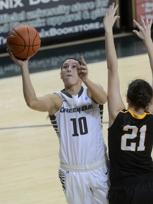 Green Bay Phoenix forward Mehryn Kraker takes a shot while being defended by Michigan Tech guard Brenna Heise in the first half. The Green Bay Phoenix defeated the Michigan Tech Huskies 74-50 at the Kress Events Center in Green Bay, Wis. on Saturday, Nov. 1, 2014.