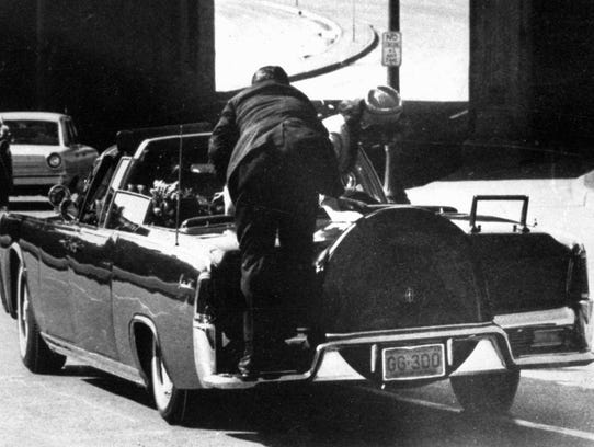 Jacqueline Kennedy, right, and a Secret Service agent react to the shooting of then-President John F. Kennedy.