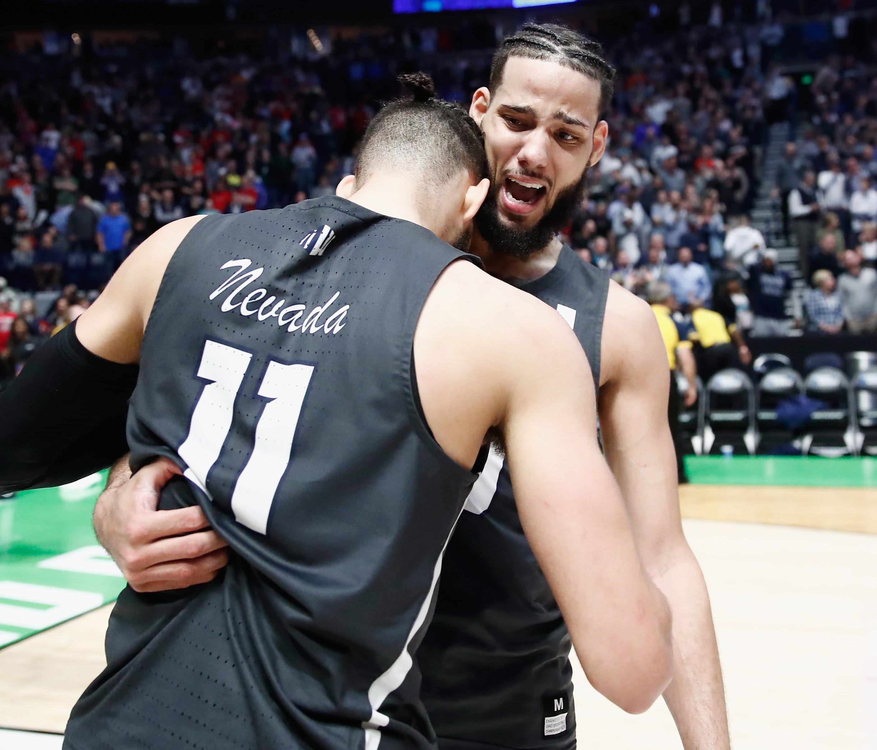 Caleb Martin celebrates with Cody Martin of the Nevada Wolf Pack after defeating the Cincinnati.
