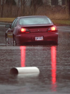 A car is abandoned in high water on North Diamond Street in this News Journal file photo.