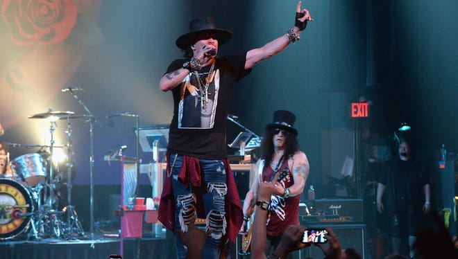 Axl Rose, left, and Slash of Guns N' Roses played an intimate show at New York's Apollo Theater to celebrate the 30th anniversary of the band's 1987 album 'Appetite for Destruction.'