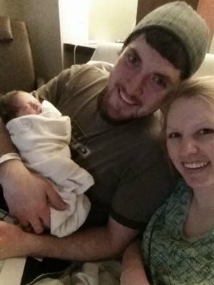 Tanner and Heather Zwetow of Stockbridge pose with their daughter, Leah, who was born Monday. Leah and Tanner share a Leap Day birthday.