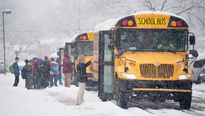 Students file out of East York Elementary for an early dismissal at 1 p.m.Tuesday because of the snow.