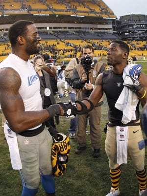 Calvin Johnson, left, and Antonio Brown exchange jerseys after the Steelers defeated the Lions, 37-27,  at Heinz Field in Pittsburgh on Nov 17, 2013.