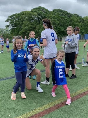 Ella Tenney is flanked by Braintree Youth Lacrosse Players Penny Delgallo and Charlotte Carey.