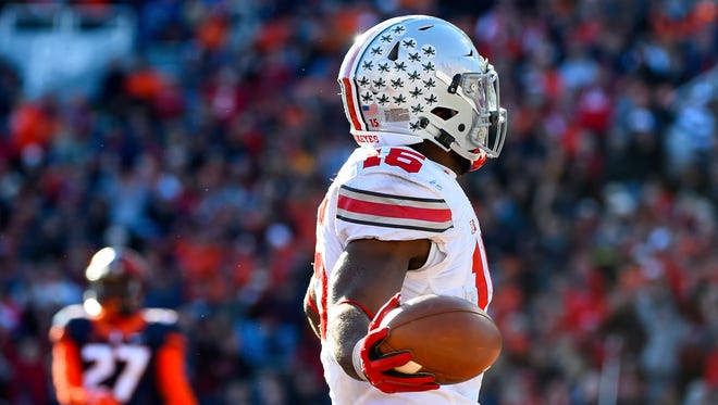 Nov 14, 2015; Champaign, IL, USA; Ohio State Buckeyes running back Ezekiel Elliott (15) reacts after scoring a touchdown against the Illinois Fighting Illini during the fourth quarter at Memorial Stadium. Ohio State defats Illinois 28-3. Mandatory Credit: Mike DiNovo-USA TODAY Sports