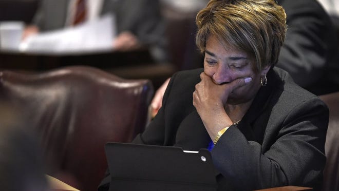 Rep. JoAnne Favors of Chattanooga studies her computer during the debate on whether to override Gov. Bill Haslam's veto of the bill seeking to make the Bible the state's official book Wednesday, April 20, 2016, in Nashville. The House voted not to override the veto. 
