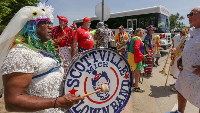 Scottville Clown Band member Herb Early  of Grand Rapids joins with other members as they prepare to march and play in a parade during the National Asparagus Festival in Hart, Mich., on  June 11, 2016.