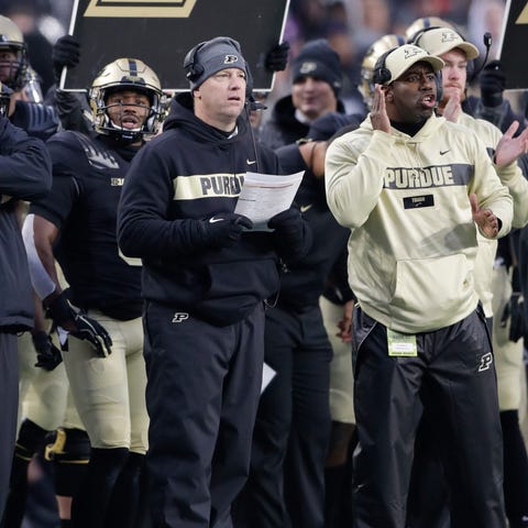 Purdue head coach Jeff Brohm calls a play from...