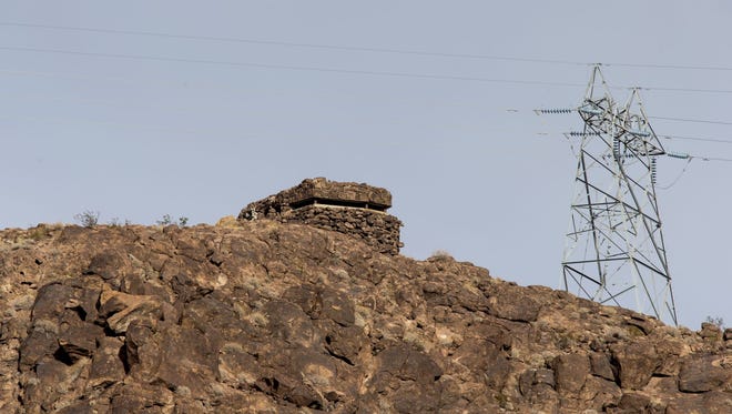 An abandoned World War II pillbox bunker sits on top of a bluff overlooking Hoover Dam from the Arizona side of Lake Mead.