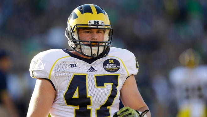 Michigan linebacker Jake Ryan gets ready to play Notre Dame in South Bend, Ind., on Sept. 6, 2014.