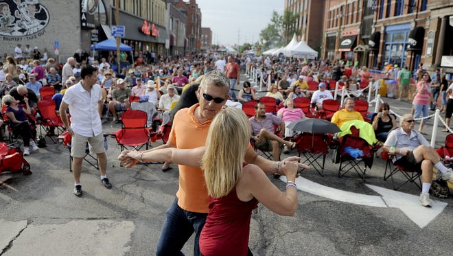 Lisa Lockwood and Don Neu dance during a Chris Hawkey Band performance during the 2014 Takin’ It To The Streets Festival.