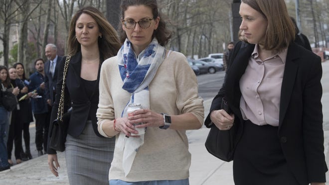 Clare Bronfman, center, leaves Federal court in the Brooklyn borough of New York, Friday, April 19, 2019. Bronfman has pleaded guilty to charges implicating her in a sex-trafficking conspiracy case against an upstate New York self-help group.