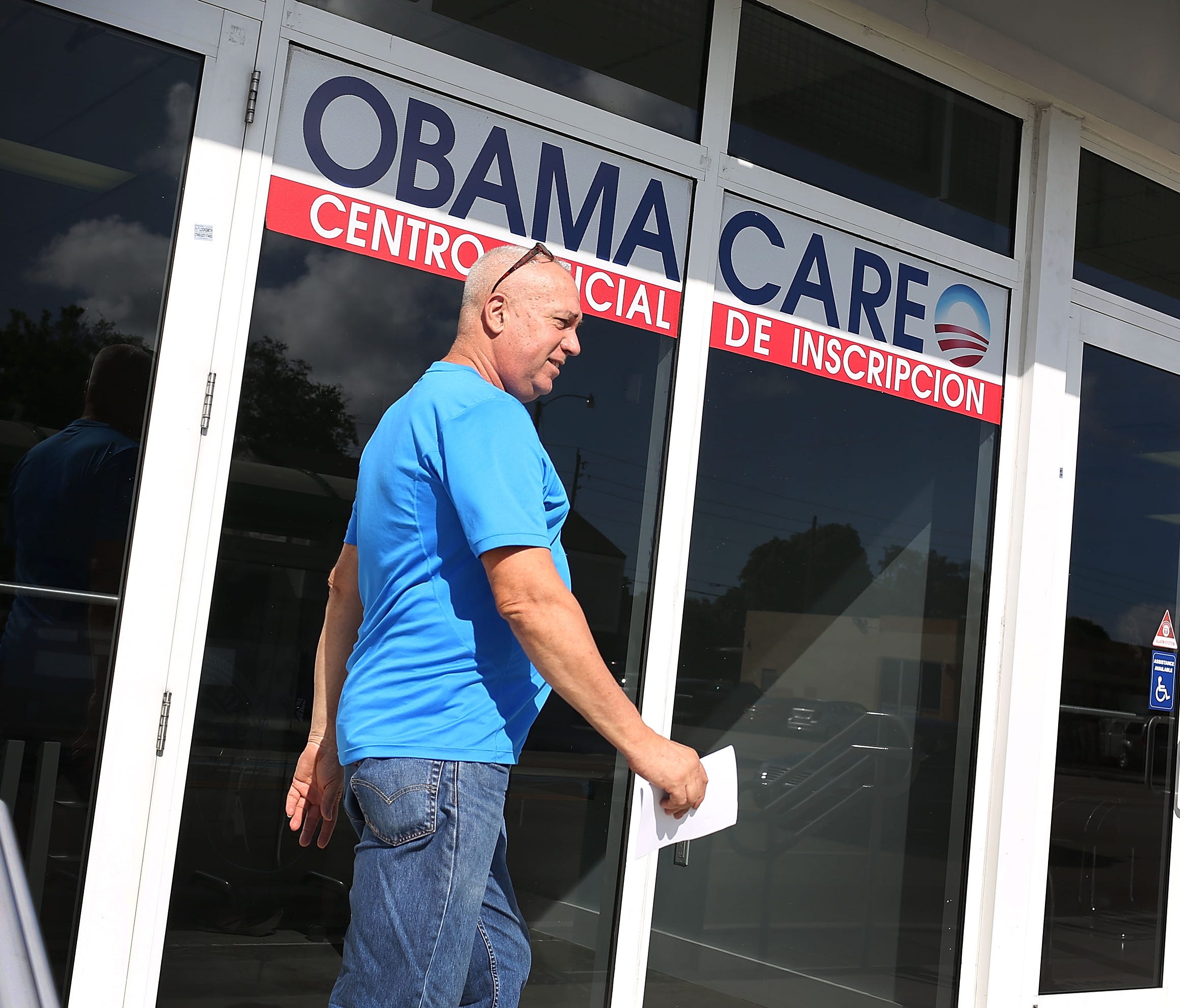 Alberto Abin walks out of the UniVista Insurance company office after shopping for a health plan under the Affordable Care Act, also known as Obamacare, on December 15, 2015 in Miami, Florida.