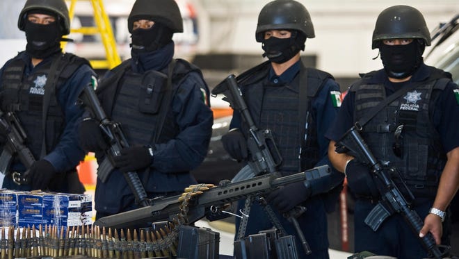 A .50-caliber sniper rifle similar to the one shown here at a 2009 press conference at the hangar of the Mexican Federal Police was found in Joaquin "Chapo" Guzman's arsenal. Guzman's weapon was among hundreds of firearms allowed into Mexico years earlier in a controversial Arizona sting operation.
