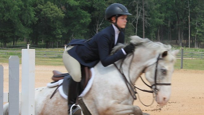 Bossier City's Casey Tonnies competes in an equestrian event.