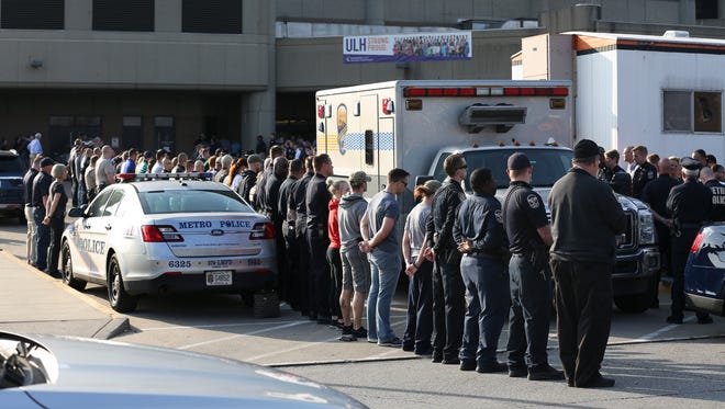 Mourners lined up outside University of Louisville Hospital beside the vehicle that would carry Louisville Metro Police Officer Nick Rodman who died after being involved in a car crash Tuesday night in the Portland neighborhood.Mar. 29, 2017